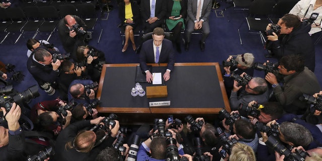Facebook CEO Mark Zuckerberg takes his seat to testify before a joint hearing of the Commerce and Judiciary Committees on Capitol Hill in Washington, Tuesday, April 10, 2018, about the use of Facebook data to target American voters in the 2016 election. (AP Photo/Pablo Martinez Monsivais)
