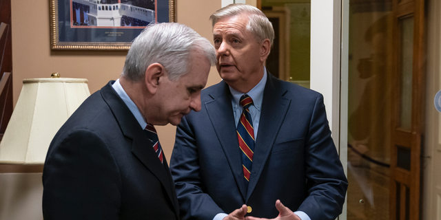 Sen. Jack Reed, D-R.I., left, and Sen. Lindsey Graham, R-S.C., members of the Senate Armed Services Committee, confer prior to a news conference to say they are disagreeing with President Donald Trump's sudden decision to pull all 2,000 U.S. troops out of Syria, at the Capitol in Washington, Thursday, Dec. 20, 2018. (AP Photo/J. Scott Applewhite)