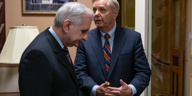 Sen. Jack Reed, D-R.I., left, and Sen. Lindsey Graham, R-S.C., members of the Senate Armed Services Committee, confer prior to a news conference to say they are disagreeing with President Donald Trump's sudden decision to pull all 2,000 U.S. troops out of Syria, at the Capitol in Washington, Thursday, Dec. 20, 2018. (AP Photo/J. Scott Applewhite)