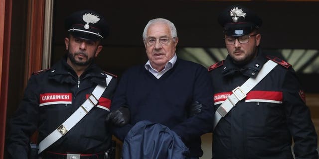 Settimino Mineo, center, who allegedly took over as the Palermo head of Cosa Nostra, is escorted by Italian Carabinieri police after an anti Mafia operation which led the arrest of 46 people including the presumed regional boss, in Palermo, Sicily, Italy, Tuesday, Dec. 4, 2018. Italian police say they have dismantled the rebuilt upper echelons of the Sicilian Mafia.