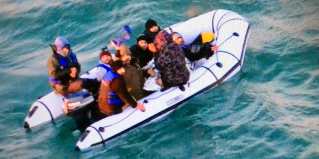 This image provided by the Marine Nationale (French Navy) shows migrants aboard a rubber boat after being intercepted by French authorities, off the port of Calais, northern France, Tuesday, Dec. 25, 2018. French authorities have rescued eight migrants, including two children, whose engine failed as they tried to sneak across the English Channel to Britain. (Marine Nationale via AP)