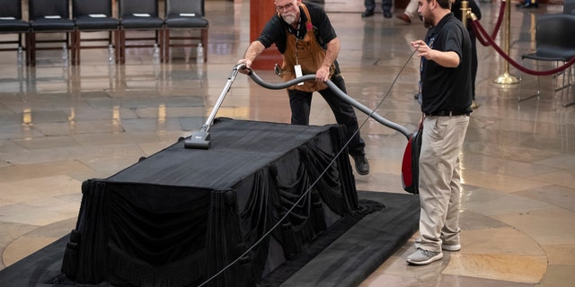 Mike Dean, lead upholsterer for the House of Representatives, and John Brady Jr., an apprentice, prepare the Lincoln catafalque for the casket of former President George H.W. Bush.