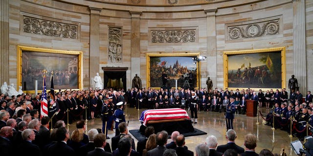 Vice President Mike Pence, right, speaks at the podium during services for former President George H.W. Bush in the Capitol Rotunda on Monday.