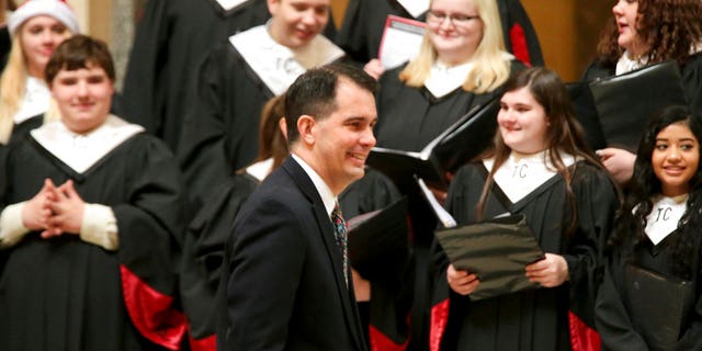 Wisconsin Gov. Scott Walker arrives for the lighting of the state Christmas Tree in the Capitol Rotunda, Tuesday, Dec. 4, 2018 at the Capitol in Madison, Wis. The Senate and Assembly are set to send dozens of changes in state law to Walker's desk Tuesday. (Steve Apps/Wisconsin State Journal via AP)