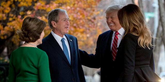 President Donald Trump and first lady Melania Trump are greeted by former President George W. Bush and former first lady Laura Bush outside the Blair House.