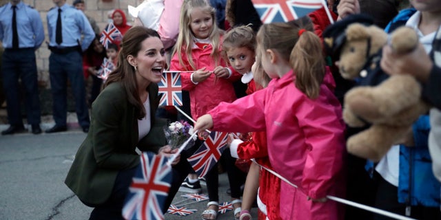 Kate, the Duchess of Cambridge, greets family members of personnel at the Akrotiri Royal Air Force base, near the south coastal city of Limassol, Cyprus, Wednesday, Dec. 5, 2018.