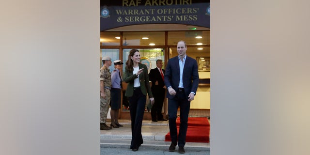 Britain's Prince William, right, and his wife Kate, the Duchess of Cambridge, stand outside the mess hall at the Akrotiri Royal Air Force base, near the south coastal city of Limassol, Cyprus, Wednesday, Dec. 5, 2018.
