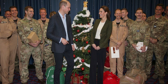 Prince William and Kate Duchess of Cambridge pose with Service Personnel during a Christmas party on RAF Akrotiri in Cyprus, as the Royal couple visit the Sergent's mess to hand out gifts Wednesday Dec. 5, 2018. The RAF Akrotiri is the home of the Cyprus Operations Support Unit which supplies support to operations in the region to protect the UK's strategic interests.