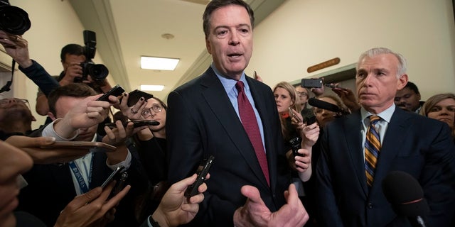 Former FBI Director James Comey, with his attorney, David Kelley, right, speaking to reporters after a day of testimony before the House Judiciary and Oversight committees, on Capitol Hill in Washington on Dec. 7.