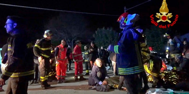 In this frame taken from video rescuers assist injured people outside a nightclub in Corinaldo, central Italy, early Saturday, Dec. 8, 2018.