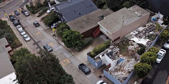 This Friday, Dec. 14, 2018, photo shows a demolished house, right, on a property in San Francisco.
