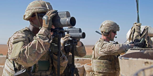 U.S. soldiers surveil the area during a combined joint patrol in Manbij, Syria.
