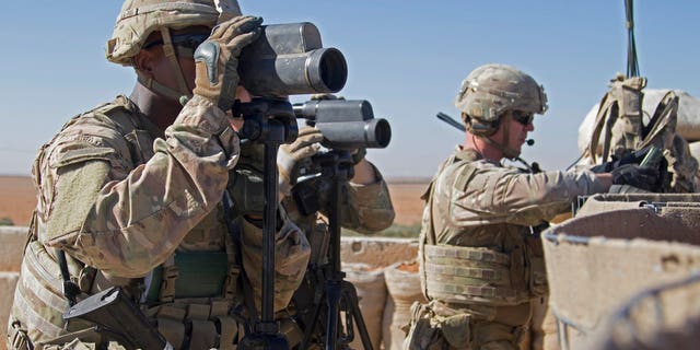 U.S. soldiers surveil the area during a combined joint patrol in Manbij, Syria.