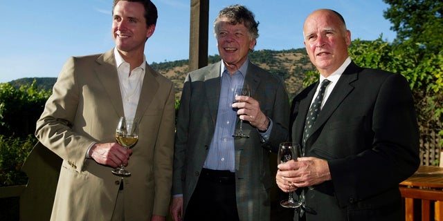 FILE - In this June 3, 2004, file photo, San Francisco Mayor Gavin Newsom, from left, Gordon Getty and Oakland Mayor Jerry Brown enjoy a pre-dinner glass of wine during a hospitality event of the Napa Valley Wine Auction at the PlumpJack Winery in Oakville, Calif. (Associated Press)