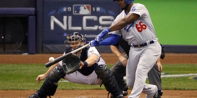 Los Angeles Dodgers batter Yasiel Puig (66) hits a three-run home run during the sixth inning of Game 7 of the National League Championship Series against the Milwaukee Brewers in Milwaukee, in October 2018. Puig, a native of Cuba, has since been traded to the Cincinnati Reds. (Associated Press)