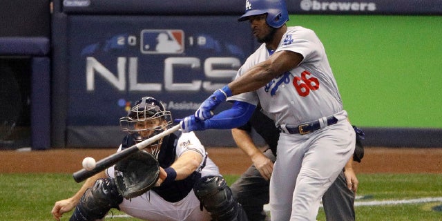 FILE: Los Angeles Dodgers' Yasiel Puig (66) hits a three -run home run during the sixth inning of Game 7 of the National League Championship Series baseball game against the Milwaukee Brewers in Milwaukee, Oct. 20, 2018.