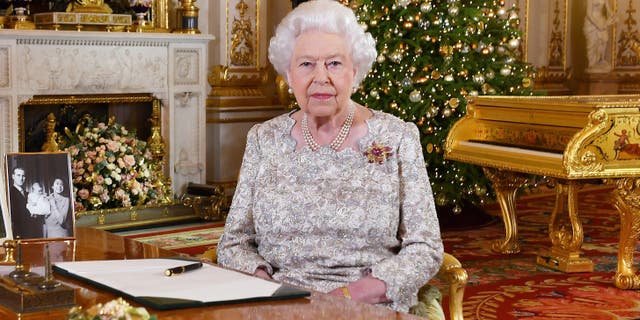 In this photo released on Monday, Dec. 24, 2018, Queen Elizabeth II poses after she recorded her annual Christmas Day message, in the White Drawing Room of Buckingham Palace in central London.