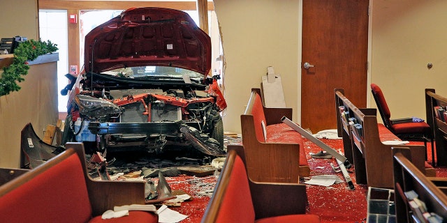 A car that crashed into the entrance of the Crossroads United Methodist Church located at 1100 Hague Avenue is visible from inside of the church on the morning of Sunday, December 23, 2018 in Columbus, Ohio. A woman drove into the church during morning services, injuring several people. (Brooke LaValley/The Columbus Dispatch via AP)