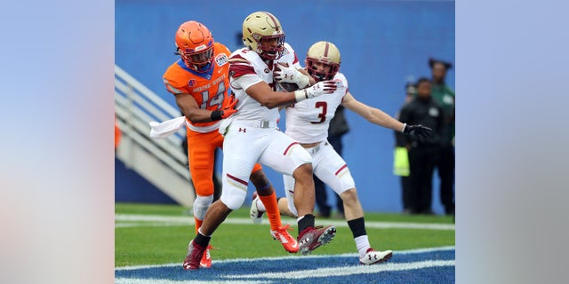 Boston College running back AJ Dillon (2) scores a touchdown ahead of Boise State cornerback Tyler Horton (14) during the first half of the First Responder Bowl NCAA football game Wednesday, Dec. 26, 2018, in Dallas. But the score won't count because the game was later canceled. (Associated Press)