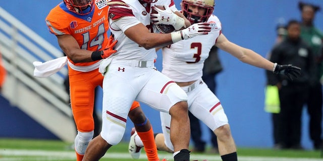 Boston College running back AJ Dillon (2) scores a touchdown ahead of Boise State cornerback Tyler Horton (14) during the first half of the First Responder Bowl NCAA football game Wednesday, Dec. 26, 2018, in Dallas. But the score won't count because the game was later canceled. (Associated Press)