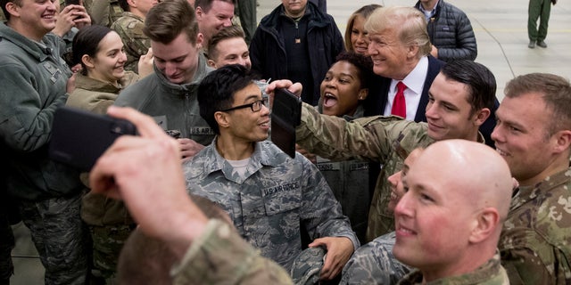 President Donald Trump and first lady Melania Trump greet members of the military at Ramstein Air Base, Germany, Thursday, Dec. 27, 2018. (AP Photo/Andrew Harnik)