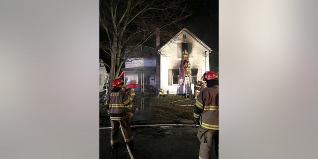 Firefighters work to extinguish a deadly fire on Friday in Tell City, Indiana.