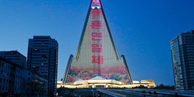A propaganda message is displayed on the facade of the pyramid-shaped Ryugyong Hotel in Pyongyang, North Korea.
