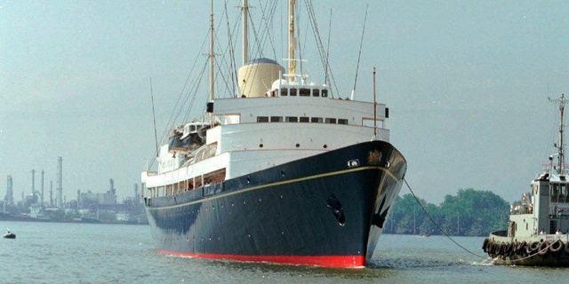 FILE - In this Friday, May 9, 1997 file photo, a long-tailed boat passes by the British Royal Yacht Britannia as it is tugged to port in Bangkok. A newly discovered note dated 1995 in the U.K.’s National Archives Saturday Dec. 29, 2018, shows that Queen Elizabeth II let government officials know she would welcome a replacement for the Royal Yacht Britannia once it was decommissioned. The Royal Yacht Britannia was in service from 1954 to 1997. (AP Photo/Charles Dharapak, file)