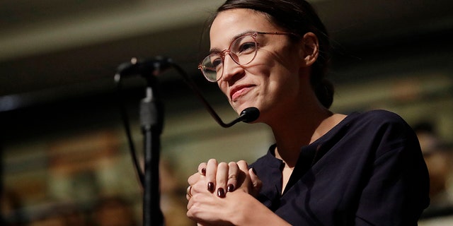 Democrat Alexandria Ocasio-Cortez, who won her bid for a seat in the House of Representatives in New York's 14th Congressional District, asks 2014 Nobel Laureate Malala Yousafzai a question at the Kennedy School's Institute of Politics at Harvard University in Cambridge, Mass., Thursday, Dec. 6, 2018.