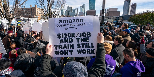 Protesters gather in Long Island City to say "No" to the Amazon "HQ2" decision on November 14, 2018 in Long Island City, New York. (Photo by Don EMMERT / AFP)