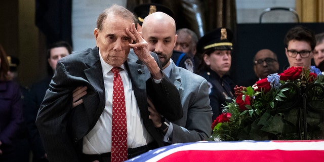 In one of the more touching moments of former President George H.W. Bush's funeral, former Sen. Bob Dole stood up and saluted the casket of the late president. (Photo by Drew Angerer/Getty Images)