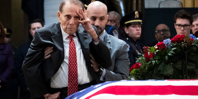 In one of the more touching moments of former President George H.W. Bush's funeral, former Sen. Bob Dole stood up and saluted the casket of the late president. (Photo by Drew Angerer/Getty Images)