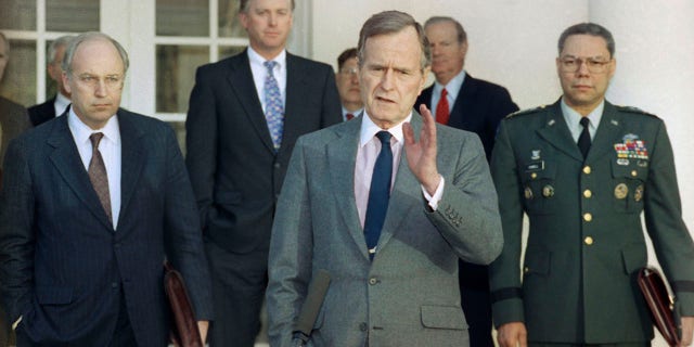 FILE - In this Feb. 11, 1991, file photo, President George H.W. Bush talks to reporters in the Rose Garden of the White House after meeting with top military advisors to discuss the Persian Gulf War. From left are, Defense Secretary Dick Cheney, Vice President Dan Quayle, White House Chief of Staff John Sununu, the president, Secretary of State James A. Baker III, and Joint Chiefs Chairman Gen. Colin Powell. Bush died at the age of 94 on Friday, Nov. 30, 2018, about eight months after the death of his wife, Barbara Bush. (AP Photo/Ron Edmonds, File)