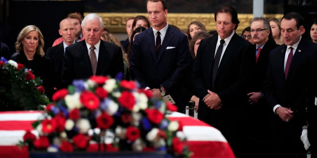 From left, women's tennis great Chris Evert, former PGA golfer Hale Irwin, former NFL football quarterback Peyton Manning, PGA golfer Phil Mickelson and Duke head basketball coach Mike Krzyzewski pay their last respect to former President George H.W. Bush as he lies in state at the U.S. Capitol on Tuesday. (Associated Press)