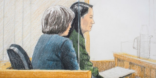 Meng Wanzhou (right), chief financial officer of Huawei Technologies, sits next to a translator at a bail hearing before the Supreme Court of British Columbia in Vancouver on Friday, December 7, 2018. Meng risks being extradited to the United States accusations of having tried to evade the sanctions imposed by the United States on Iran. She appeared in a Vancouver court on Friday to demand bail. (Jane Wolsak / The Canadian Press via AP)