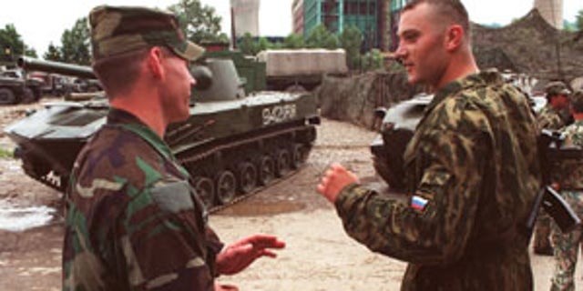 Cpt. Chad Storlie (left) talks with a Russian paratrooper during Russian Airborne Day, at Camp Ugljevik. Storlie is from Company A, 2nd Battalion 10th Special Forces Group. (Courtesy of the author)