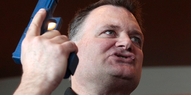 Firearm instructor Clark Aposhian holds a handgun up as he teaches a concealed-weapons training class to 200 Utah teachers on Dec. 27, 2012 in West Valley City, Utah. (Getty Images)
