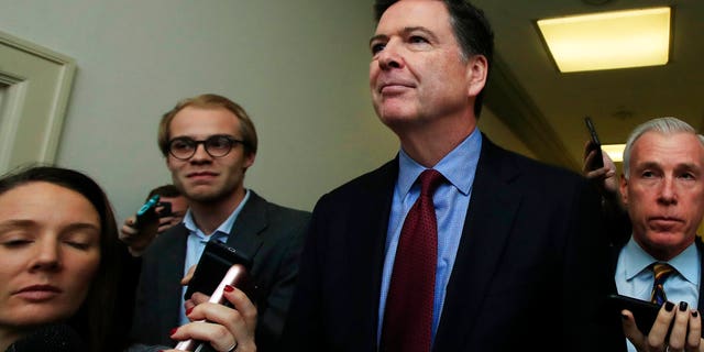 Former FBI Director James Comey speaks to reporters after testifying under subpoena behind closed doors before the House Judiciary and Oversight Committee on Capitol Hill in Washington, Friday, Dec. 7, 2018. (AP Photo/Manuel Balce Ceneta)