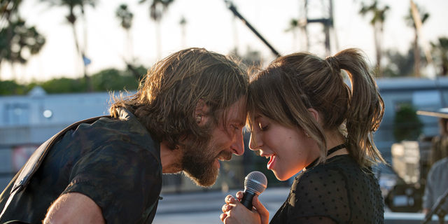 This image released by Warner Bros. shows Bradley Cooper, left, and Lady Gaga in a scene from the latest reboot of the film, 'A Star is Born.'