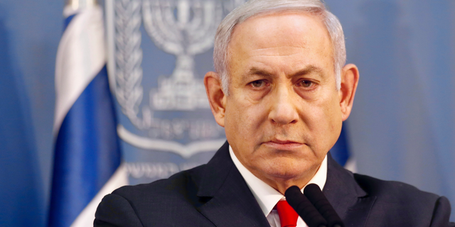 FILE - In this Nov. 18, 2018 file photo, Israeli Prime Minister Benjamin Netanyahu delivers a statement in Tel Aviv, Israel. Israeli media is reporting Monday, Dec. 24, 2018, that Prime Minister Benjamin Netanyahu’s ruling coalition government has agreed to call an early election for April 9. (AP Photo/Ariel Schalit, File)