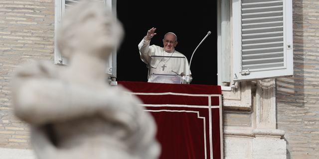 Pope Francis waves to faithful during the Angelus noon prayer in St. Peter's Square, at the Vatican, Sunday, Dec. 16, 2018. (AP Photo/Gregorio Borgia)