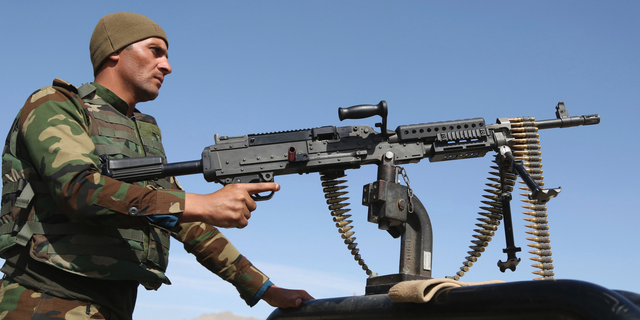 In this Wednesday, Oct. 17, 2018, photo, Afghan National Army soldiers stand guard at a checkpoint in Kabul, Afghanistan. The Taliban welcomed the news of the U.S. plan to withdraw half its troops in Afghanistan by the summer, while Afghan generals warned Friday Dec. 21, 2018, it would be a blow to the morale of the country's beleaguered security forces, who come under daily attacks from the insurgent fighters. (AP Photo/Rahmat Gul)