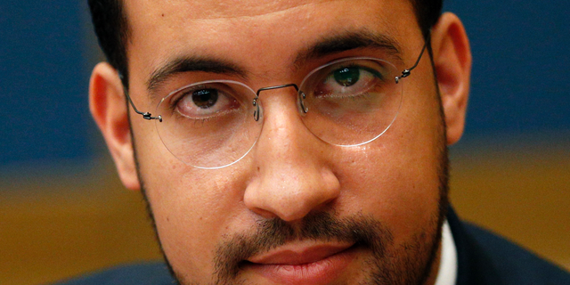 FILE - In this Wednesday, Sept. 19, 2018 file picture former President Macron's security aide Alexandre Benalla appears before the French Senate Laws Commission prior to his hearing, in Paris, France. France's Foreign Ministry is threatening legal action against a former security aide to President Emmanuel Macron, amid reports that he continued using his diplomatic passports after being fired for beating a protester. (AP Photo/Thibault Camus, File)