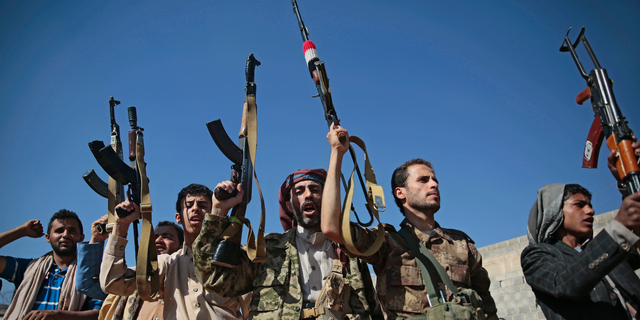 In this Dec. 13, 2018, file, photo, tribesmen loyal to Houthi rebels hold up their weapons as they attend a gathering to show their support for the ongoing peace talks being held in Sweden, in Sanaa, Yemen. The United Nations has cast doubt on the claims by Yemen’s Shiite rebels to have withdrawn from the port of Hodeida, saying such steps can only be credible if all other parties can verify them.
