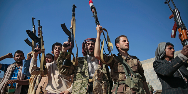 In this Dec. 13, 2018, file, photo, tribesmen loyal to Houthi rebels hold up their weapons as they attend a gathering to show their support for the ongoing peace talks being held in Sweden, in Sanaa, Yemen. The United Nations has cast doubt on the claims by Yemen’s Shiite rebels to have withdrawn from the port of Hodeida, saying such steps can only be credible if all other parties can verify them.