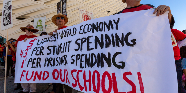 In this Saturday, Dec. 15, 2018, photo, thousands of teachers rally outside The Broad, a contemporary art museum downtown Los Angeles. Teachers in the nation's second-largest school district will go on strike next month if there's no settlement of its long-running contract dispute, union leaders said Wednesday, Dec. 19. The announcement by United Teachers Los Angeles threatens the first strike against the Los Angeles Unified School District in nearly 30 years and follows about 20 months of negotiations. (AP Photo/Damian Dovarganes)