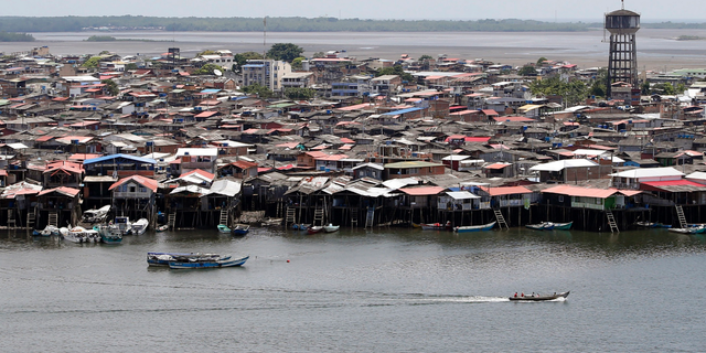 FILE - In this April, 18, 2018, boats cruise along Tumaco in southern Colombia. An investigation by Human Rights Watch found former guerrillas are waging a brutal campaign of violence in the port city of Tumaco fueled by booming coca production, a lack of basic infrastructure and disillusionment with peace. (AP Photo/Fernando Vergara, File)
