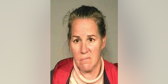 This booking photo released Tuesday, Dec. 18, 2018, by the Fresno Police Department shows Joy Collins. Police in central California say Collins has been arrested on felony child neglect charges after her 8-year-old daughter was killed as she crawled under a train in downtown Fresno on Monday evening. Fresno Police Chief Jerry Dyer said Collins urged the girl and her 9-year-old brother to crawl under the idling train so the family wouldn't miss a bus home. (Fresno Police Department via AP)