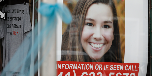 FILE - In this Aug. 21, 2018, file photo, a poster for missing University of Iowa student Mollie Tibbetts hangs in the window of a local business in Brooklyn, Iowa. (AP Photo/Charlie Neibergall, File)