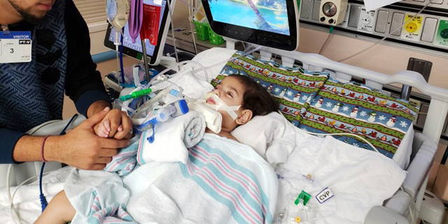FILE - This recent undated photo, released Monday, Dec. 17, 2018, by the Council on American-Islamic Relations in Sacramento, Calif., shows Ali Hassan with his dying 2-year-old son Abdullah in a Sacramento hospital. Abdullah Hassan, the son of a Yemeni woman who sued the Trump administration to let her into the country to be with the ailing boy has died. The Council on American-Islamic Relations announced Friday, Dec. 28 that Abdullah died in an Oakland, Calif., hospital. He suffered from a genetic brain condition. (Council on American-Islamic Relations via AP, File)
